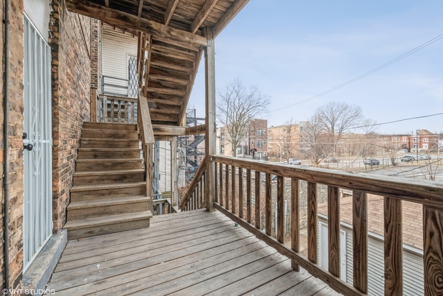 6320 South Drexel Avenue, Unit 3 Chicago, IL 60637 - Photo 13 of 13 a view of a balcony with wooden floor and fence