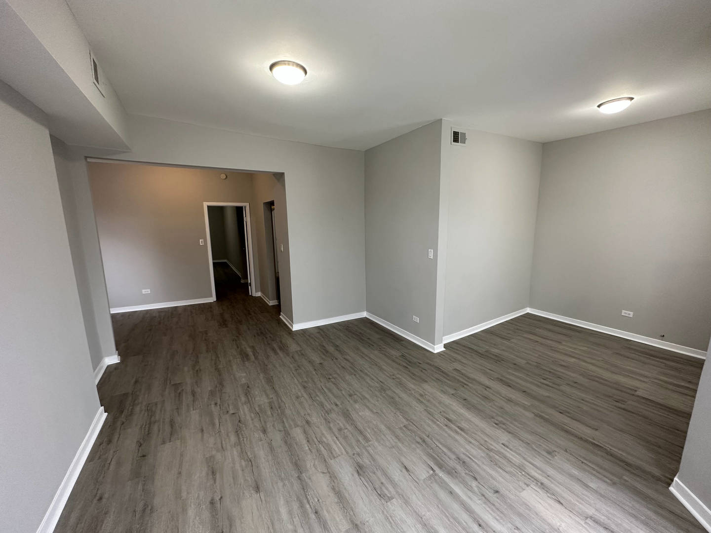 6320 South Drexel Avenue, Unit 3 Chicago, IL 60637 - Photo 4 of 13 wooden floor in an empty room with a window