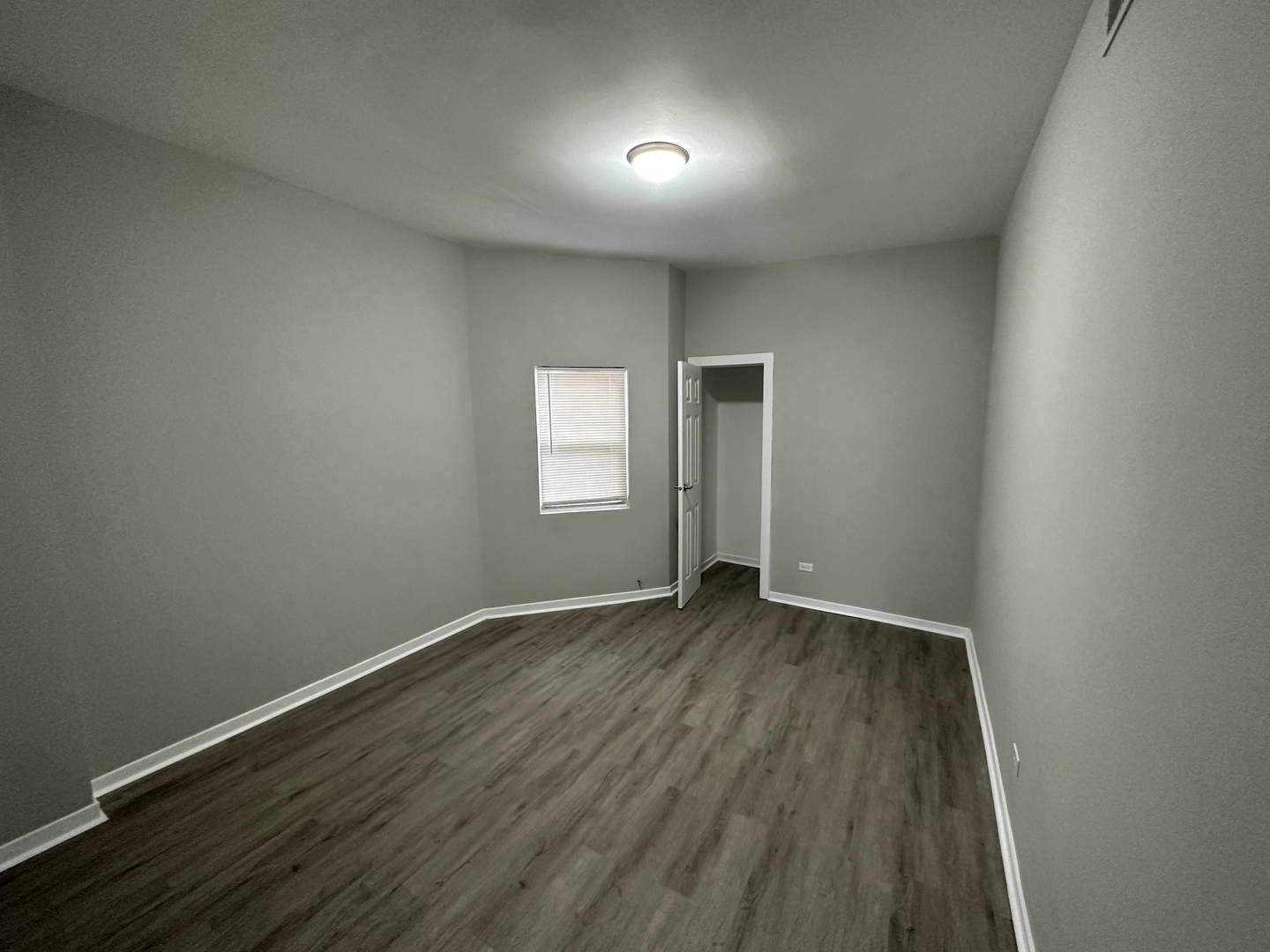 6320 South Drexel Avenue, Unit 3 Chicago, IL 60637 - Photo 5 of 13 an empty room with wooden floor and windows