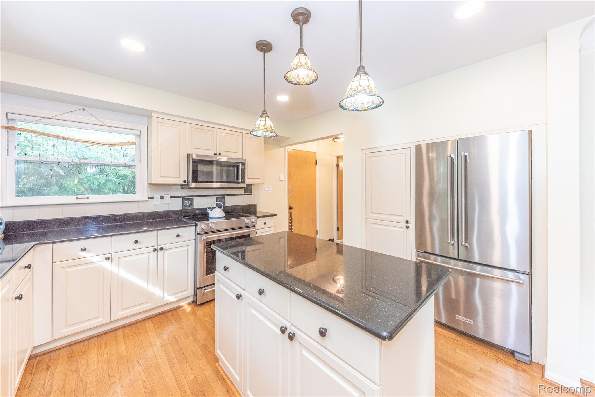 3887 Stonecrest Road West Bloomfield, MI 48322 - Photo 36 of 45 Kitchen featuring a central island, stainless steel appliances, recessed lighting, pendant lighting, and wood-finish flooring