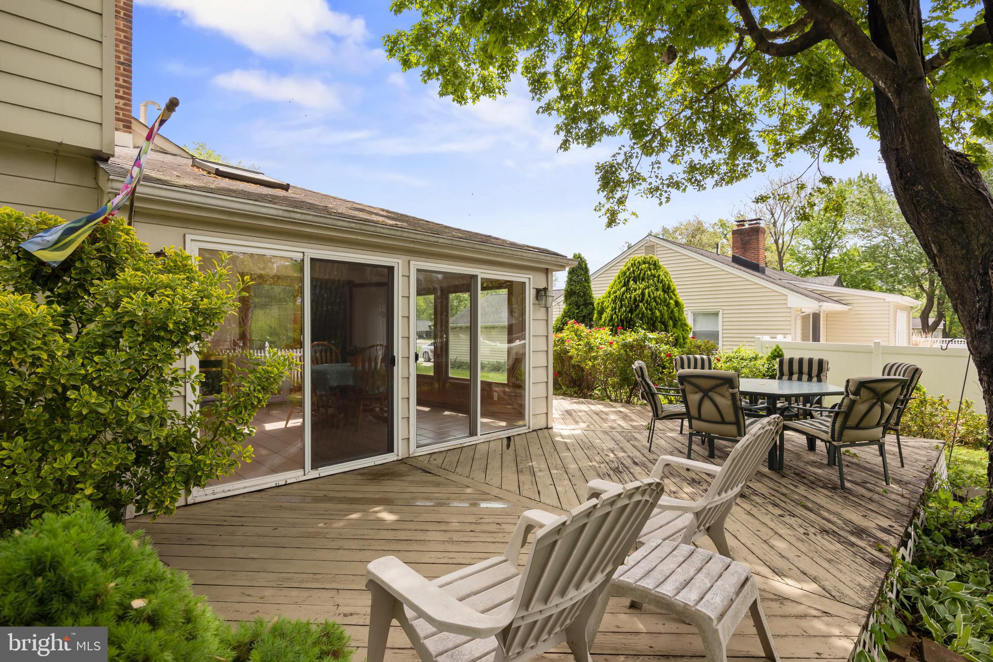 100 Sawmill Road Cherry Hill, NJ 08034 - Photo 33 of 35 a view of a patio with table and chairs potted plants and floor to ceiling window and wooden floor