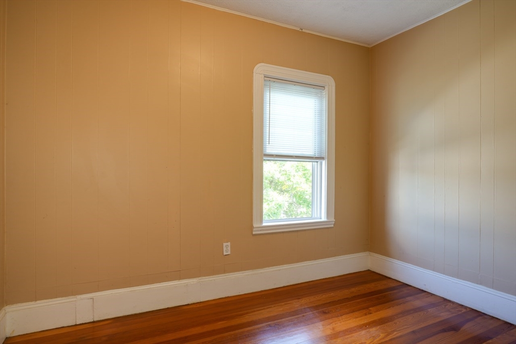 99 Beech Street Belmont, MA 02478 - Photo 12 of 37 a view of an empty room with wooden floor and a window