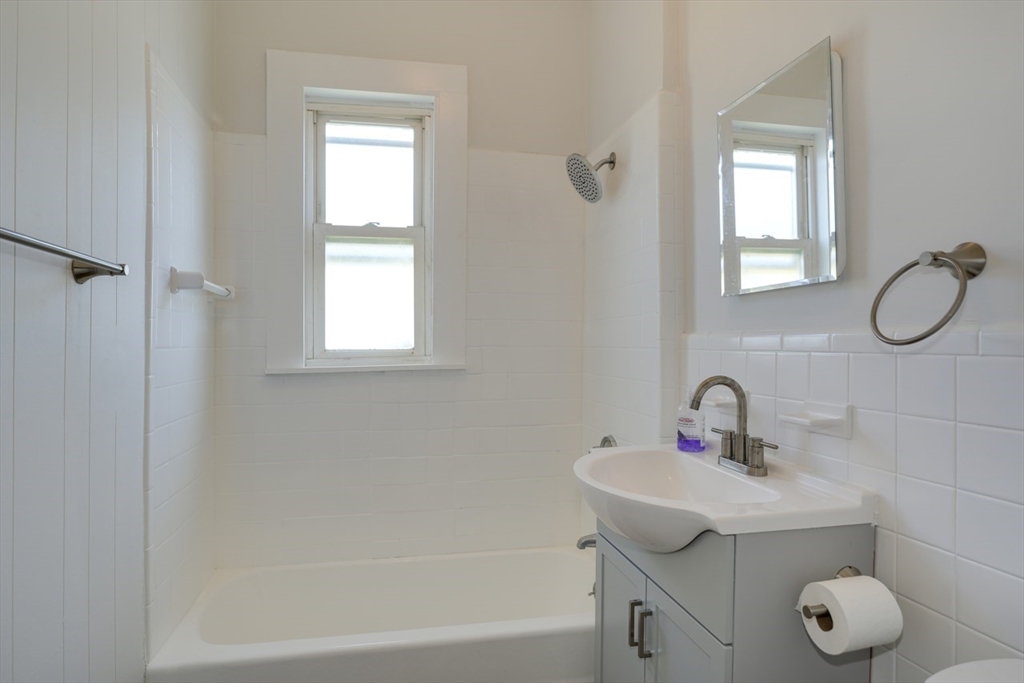 99 Beech Street Belmont, MA 02478 - Photo 13 of 37 a bathroom with a sink mirror and window