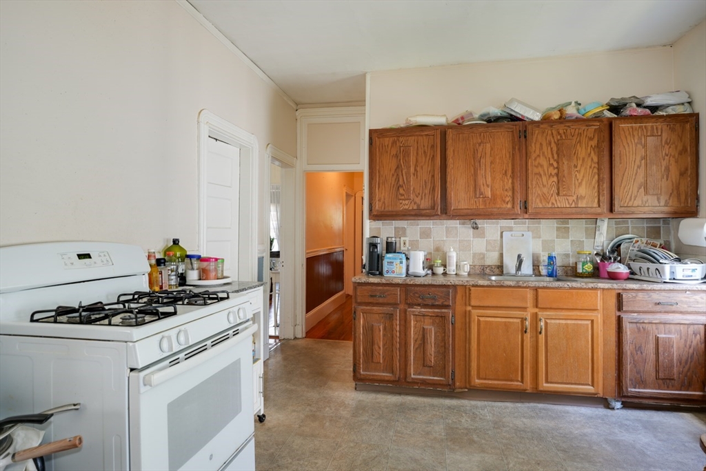 99 Beech Street Belmont, MA 02478 - Photo 14 of 37 a kitchen with stainless steel appliances a stove a sink a refrigerator and cabinets