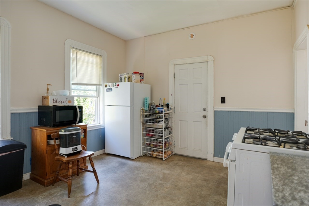99 Beech Street Belmont, MA 02478 - Photo 15 of 37 a room with a refrigerator and a stove top oven