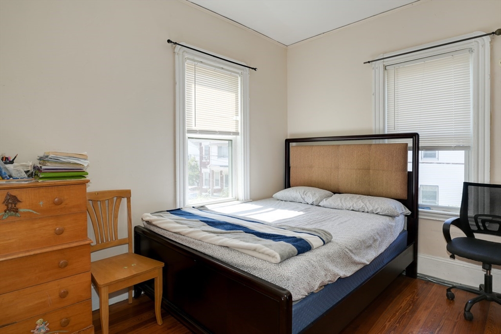 99 Beech Street Belmont, MA 02478 - Photo 19 of 37 a bedroom with a bed and wooden floor