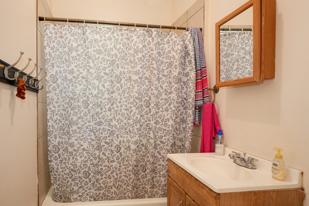 99 Beech Street Belmont, MA 02478 - Photo 21 of 37 a bathroom with a sink and a shower curtain