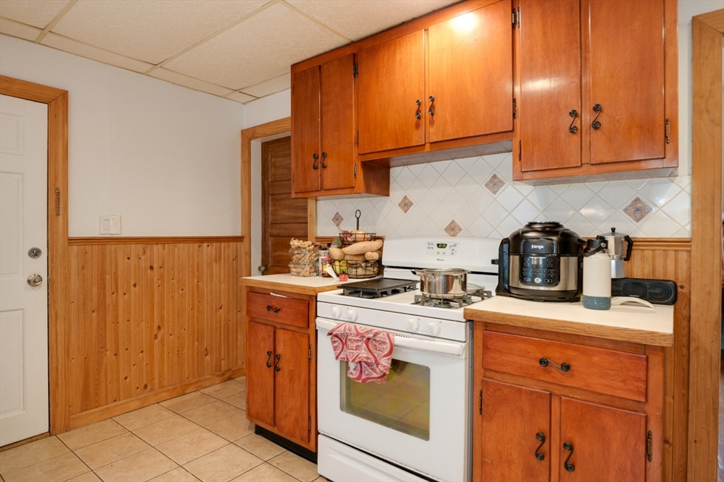 99 Beech Street Belmont, MA 02478 - Photo 22 of 37 a kitchen with stainless steel appliances granite countertop a stove and a cabinets