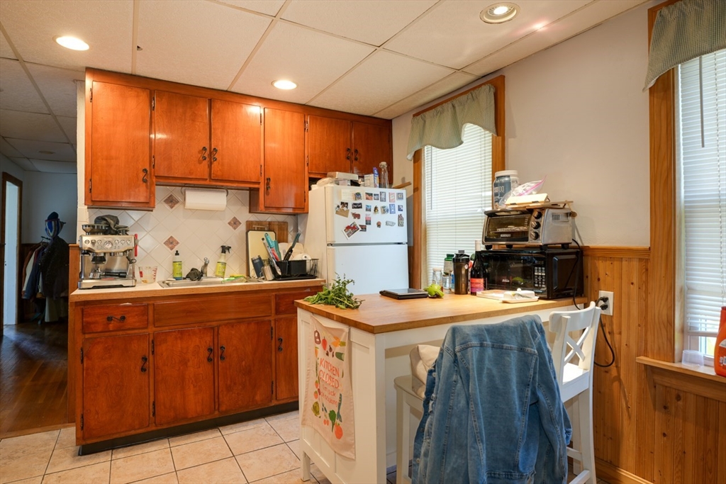 99 Beech Street Belmont, MA 02478 - Photo 24 of 37 a kitchen with a stove and a refrigerator