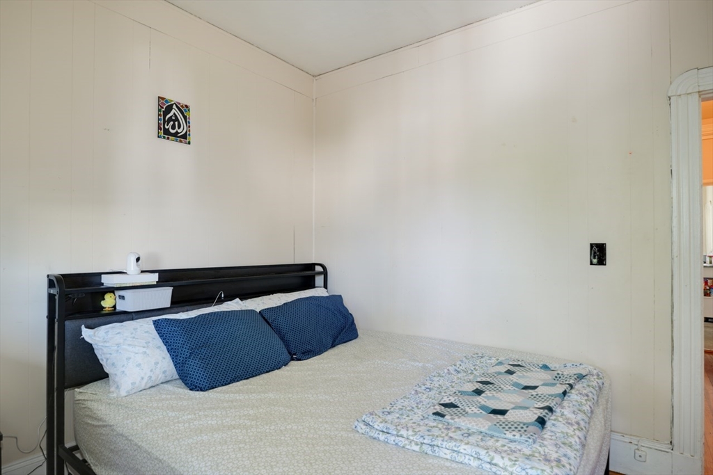 99 Beech Street Belmont, MA 02478 - Photo 28 of 37 a bedroom with a bed and a lamp on dresser
