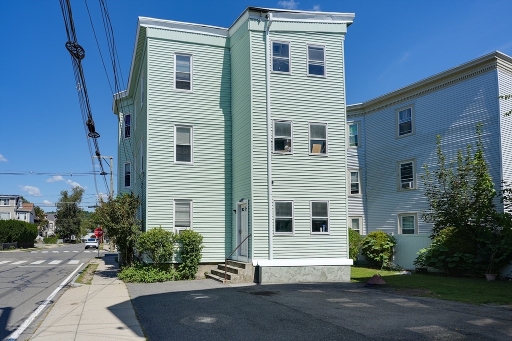 99 Beech Street Belmont, MA 02478 - Photo 3 of 37 a front view of a house with a garden