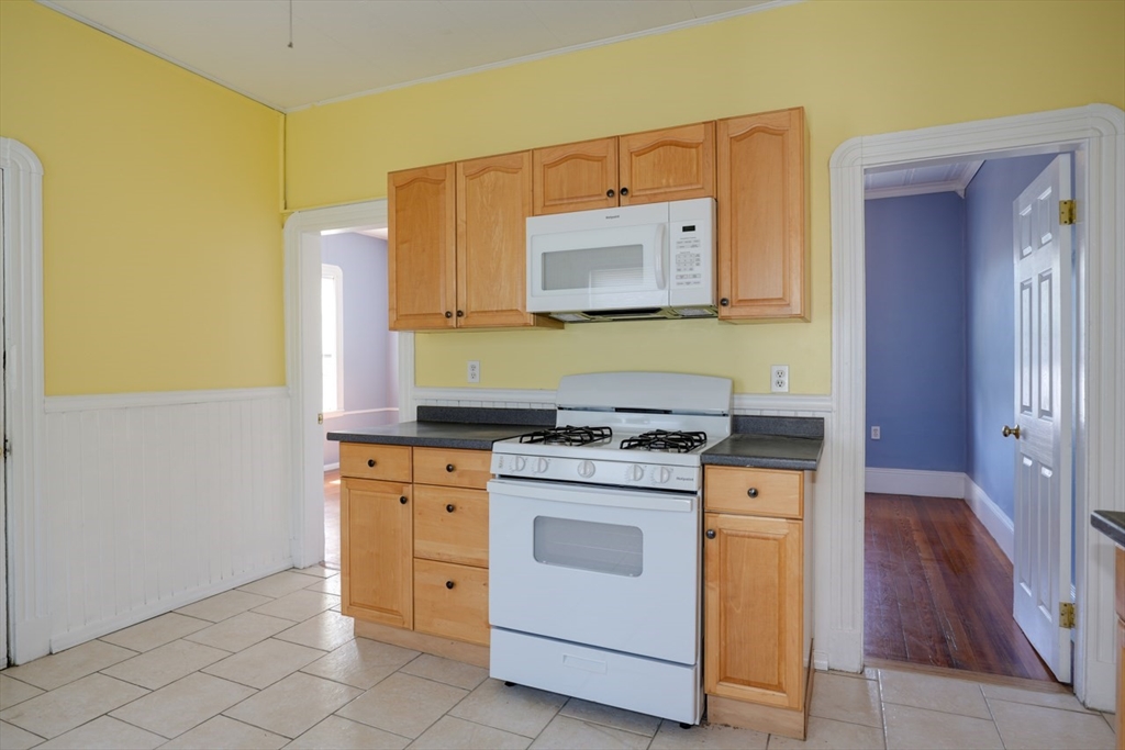 99 Beech Street Belmont, MA 02478 - Photo 4 of 37 a kitchen with cabinets appliances and wooden floor