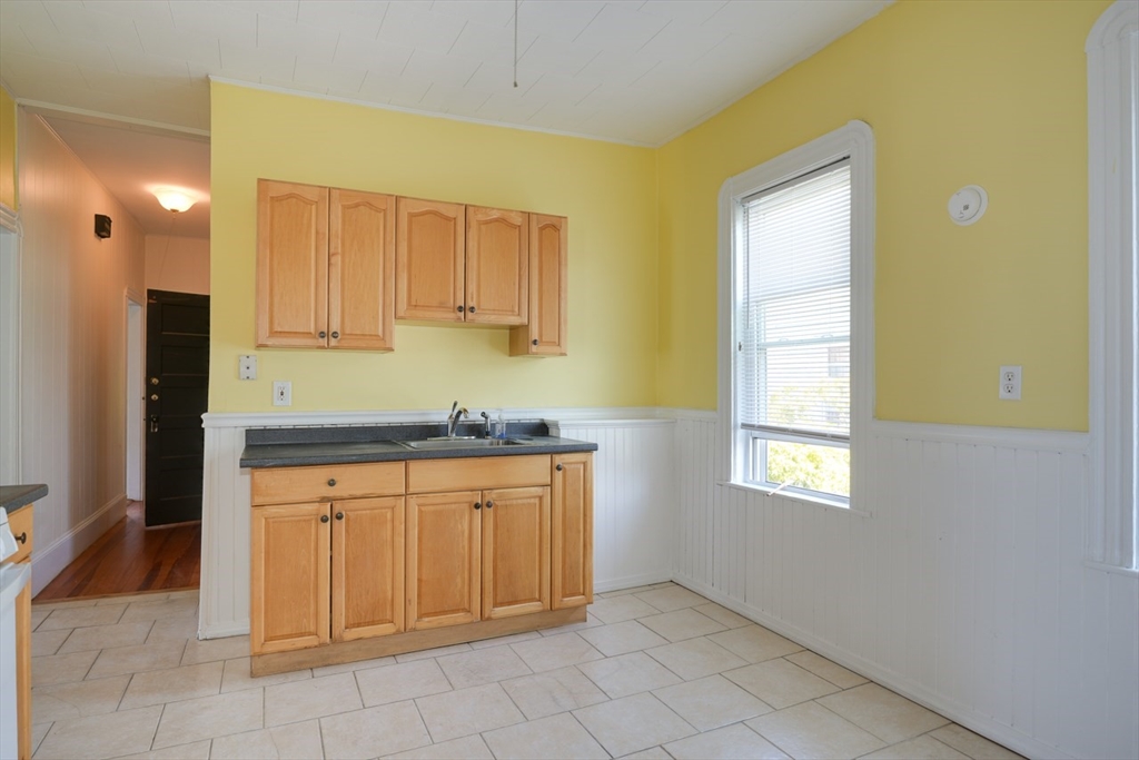 99 Beech Street Belmont, MA 02478 - Photo 6 of 37 a kitchen with granite countertop white cabinets and stainless steel appliances