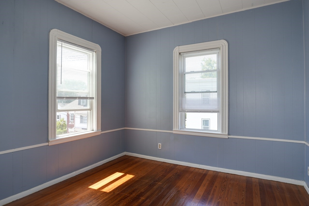 99 Beech Street Belmont, MA 02478 - Photo 10 of 37 a view of an empty room with wooden floor and a window