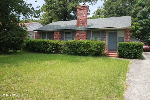 a view of front door and potted plants
