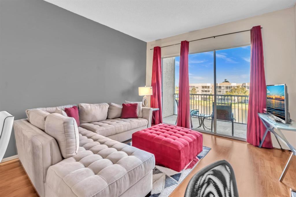 7802 Trent Drive, Unit 406 Fort Lauderdale, FL 33321 - Photo 16 of 70 a living room with furniture and a flat screen tv
