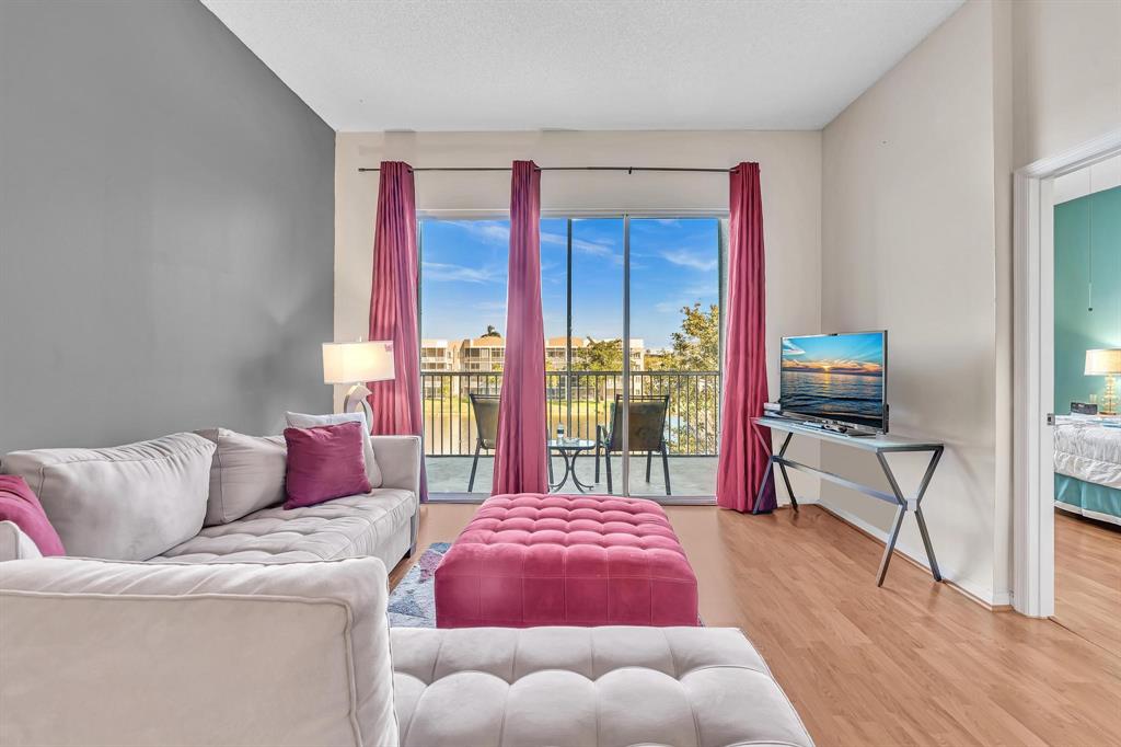 7802 Trent Drive, Unit 406 Fort Lauderdale, FL 33321 - Photo 18 of 70 a bedroom with furniture and a large window