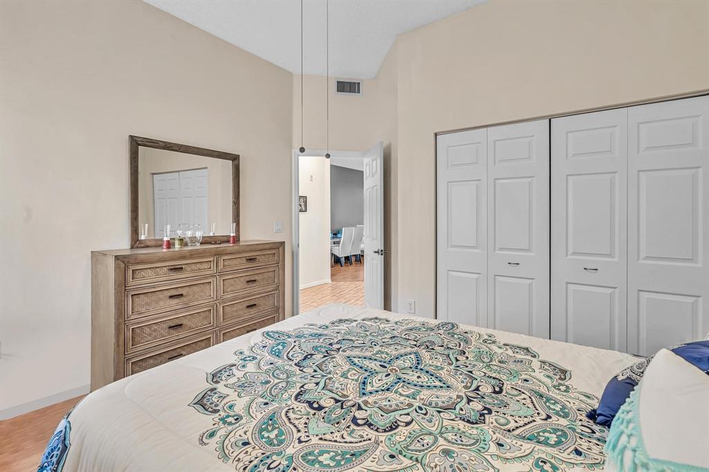7802 Trent Drive, Unit 406 Fort Lauderdale, FL 33321 - Photo 26 of 70 a bed room with a bed and a mirror