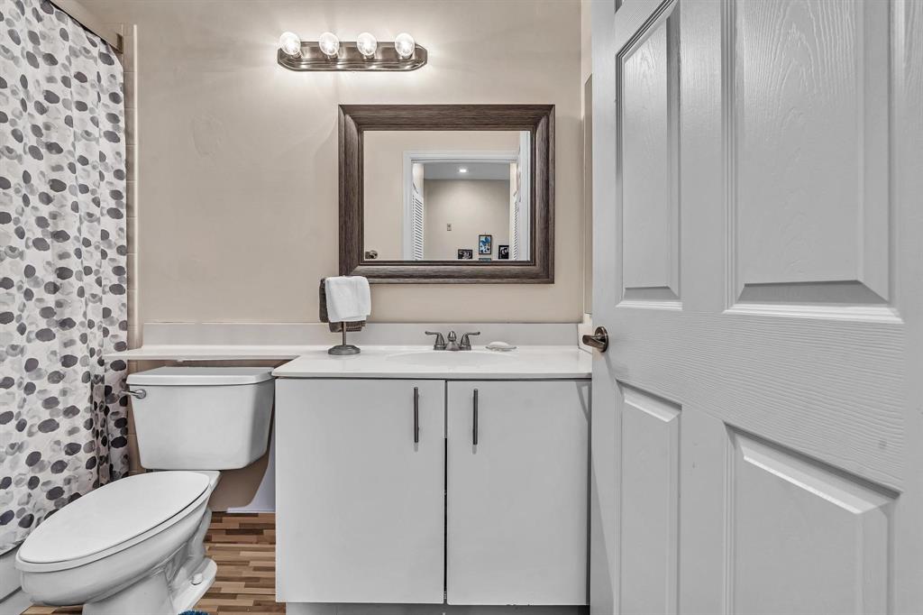 7802 Trent Drive, Unit 406 Fort Lauderdale, FL 33321 - Photo 27 of 70 a bathroom with a granite countertop toilet sink and mirror