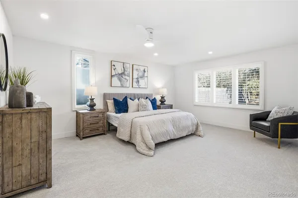 a spacious bedroom with a bed and a couch