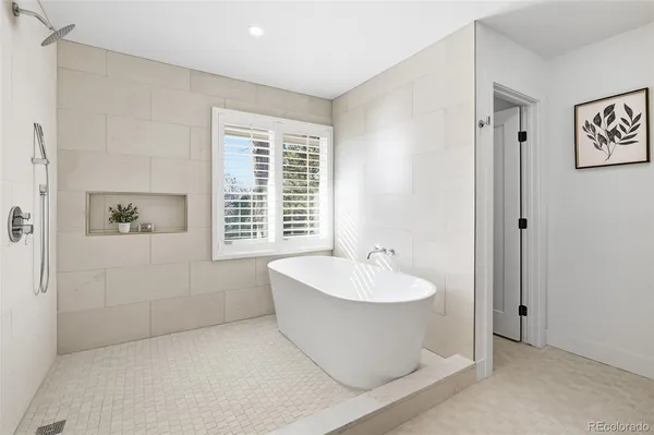 a spacious bathroom with a bathtub and next to a window