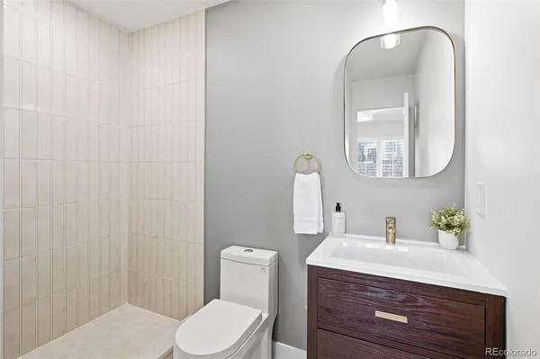 a bathroom with a toilet a sink and mirror