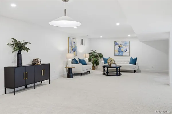 a living room with furniture and a potted plant