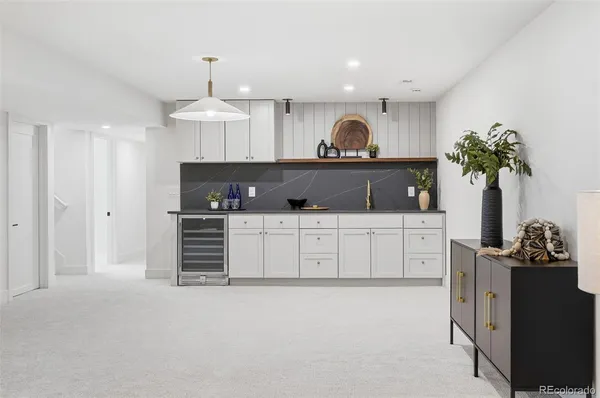 a kitchen with granite countertop a sink and cabinets