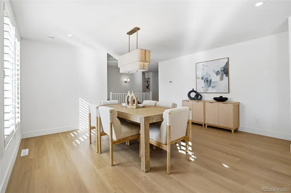 a dining room with furniture and wooden floor