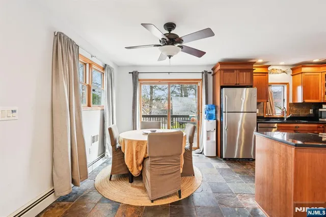 a view of a dining room with a table and chairs