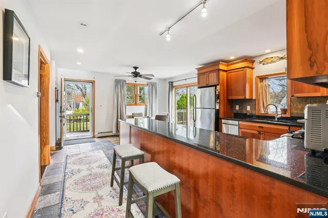 a large white kitchen with large windows and a counter space