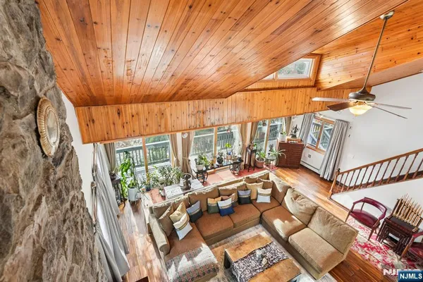 a view of a patio with table and chairs with wooden floor and fence