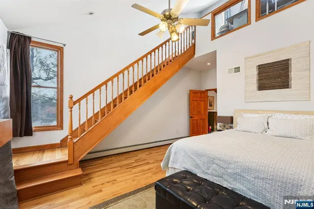 a bedroom with a bed and a wooden floor