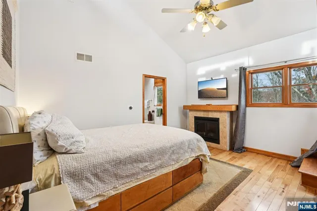 a bedroom with a bed and a fireplace