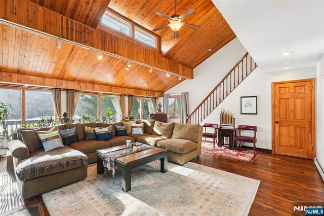 a living room with furniture a fireplace and a wooden floor