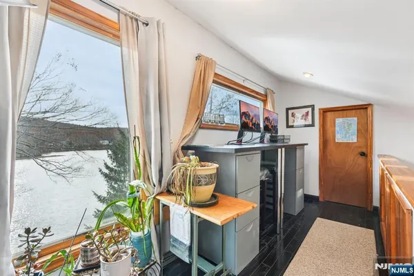 a view of a room that has a bed and a table in it