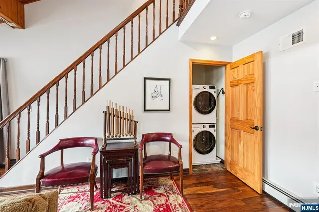 a view of entryway kitchen and hall with wooden floor