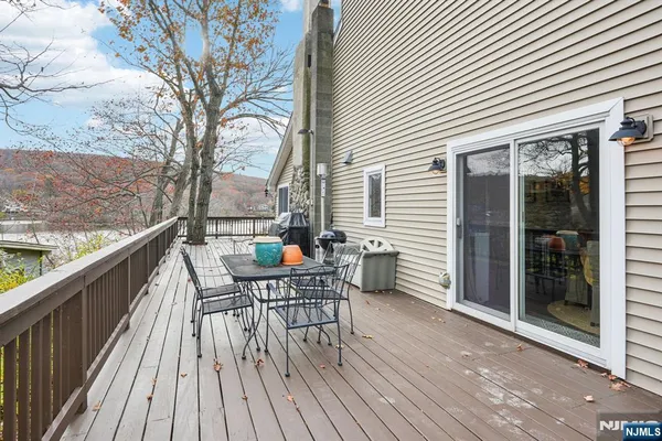a view of a roof deck with table and chairs and wooden floor