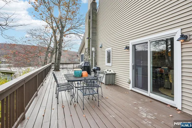 a view of a roof deck with table and chairs and wooden floor