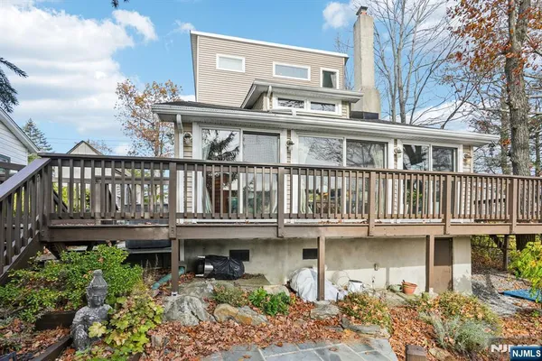 a front view of a house with a garden and balcony