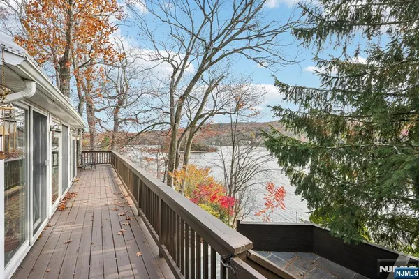 a view of balcony with wooden floor and bench