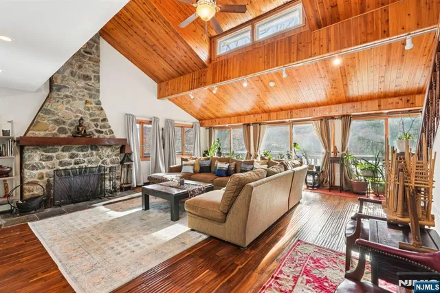 a living room with fireplace furniture and a floor to ceiling window