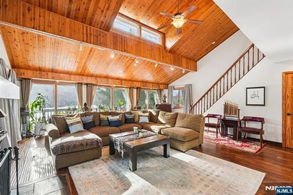 a living room with furniture a fireplace and a table