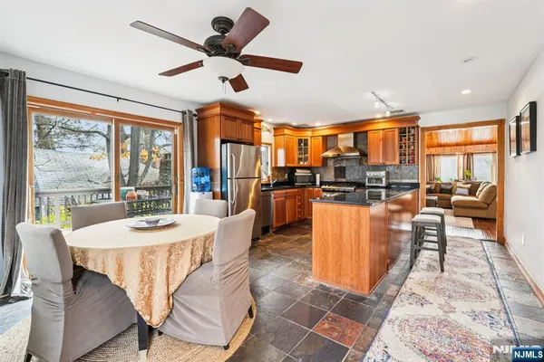 a dining room with furniture a large window and a chandelier