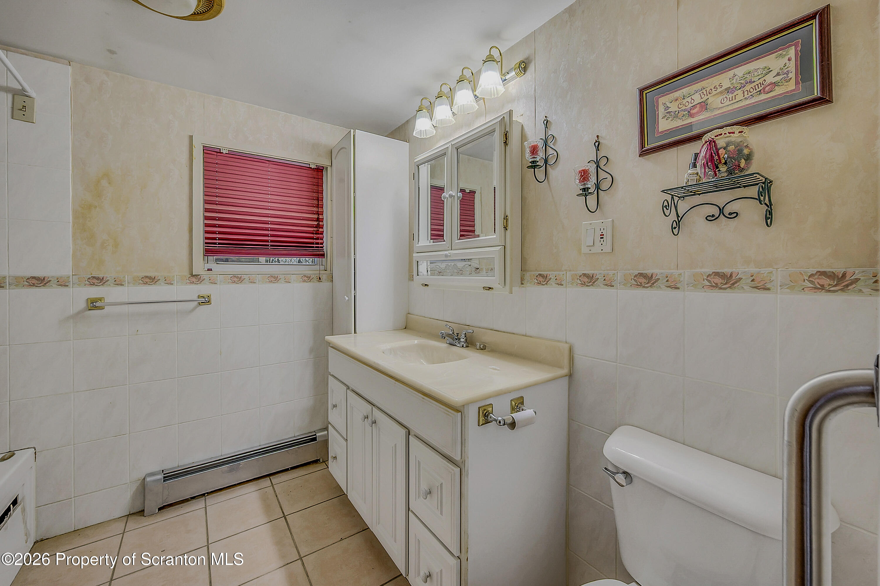 1050 Mark Avenue Dunmore, PA 18510 - Photo 14 of 35 a bathroom with a sink toilet and a mirror