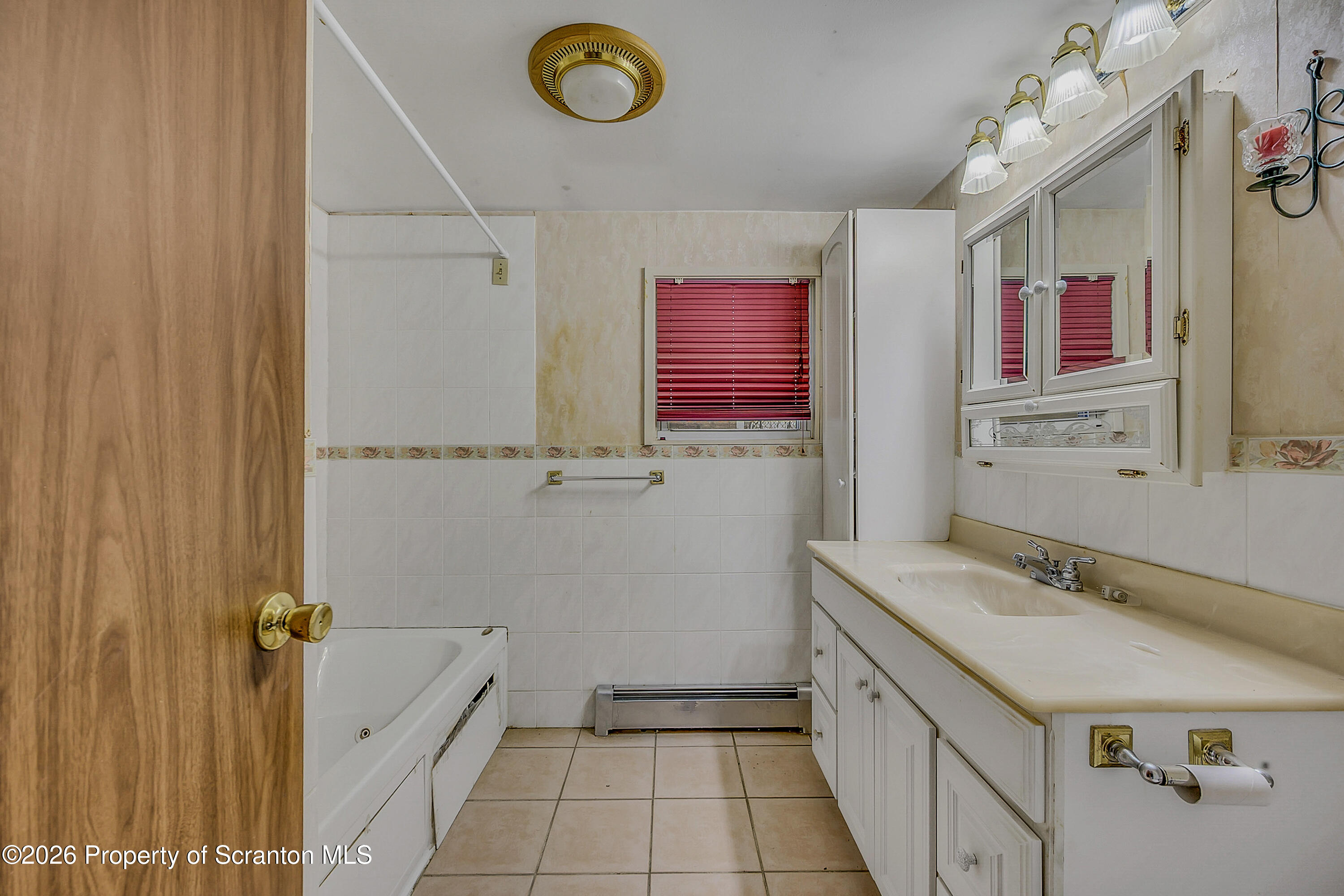 1050 Mark Avenue Dunmore, PA 18510 - Photo 16 of 35 a bathroom with a sink a vanity and a mirror