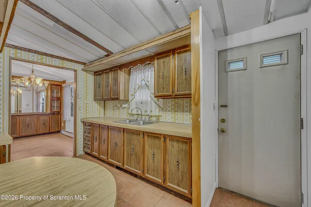 an empty room with a window and wooden floor