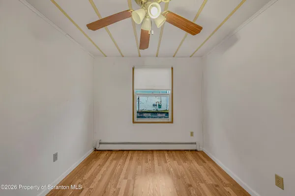 a view of a hallway with a chandelier fan