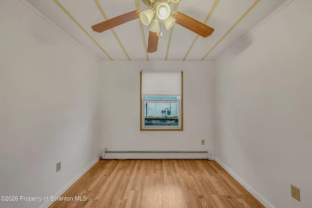 a view of a hallway with a chandelier fan