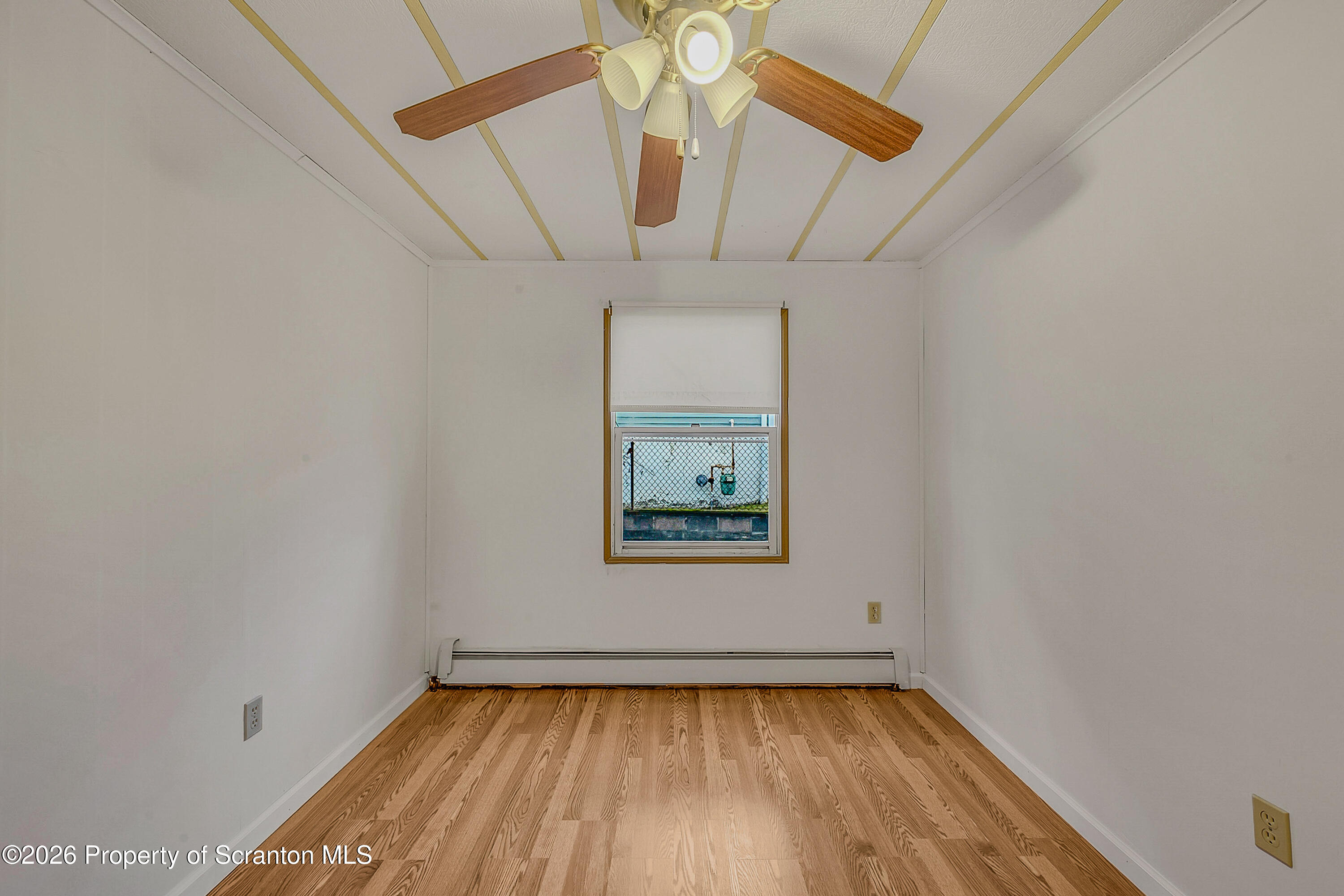 1050 Mark Avenue Dunmore, PA 18510 - Photo 24 of 35 an empty room with a window and wooden floor